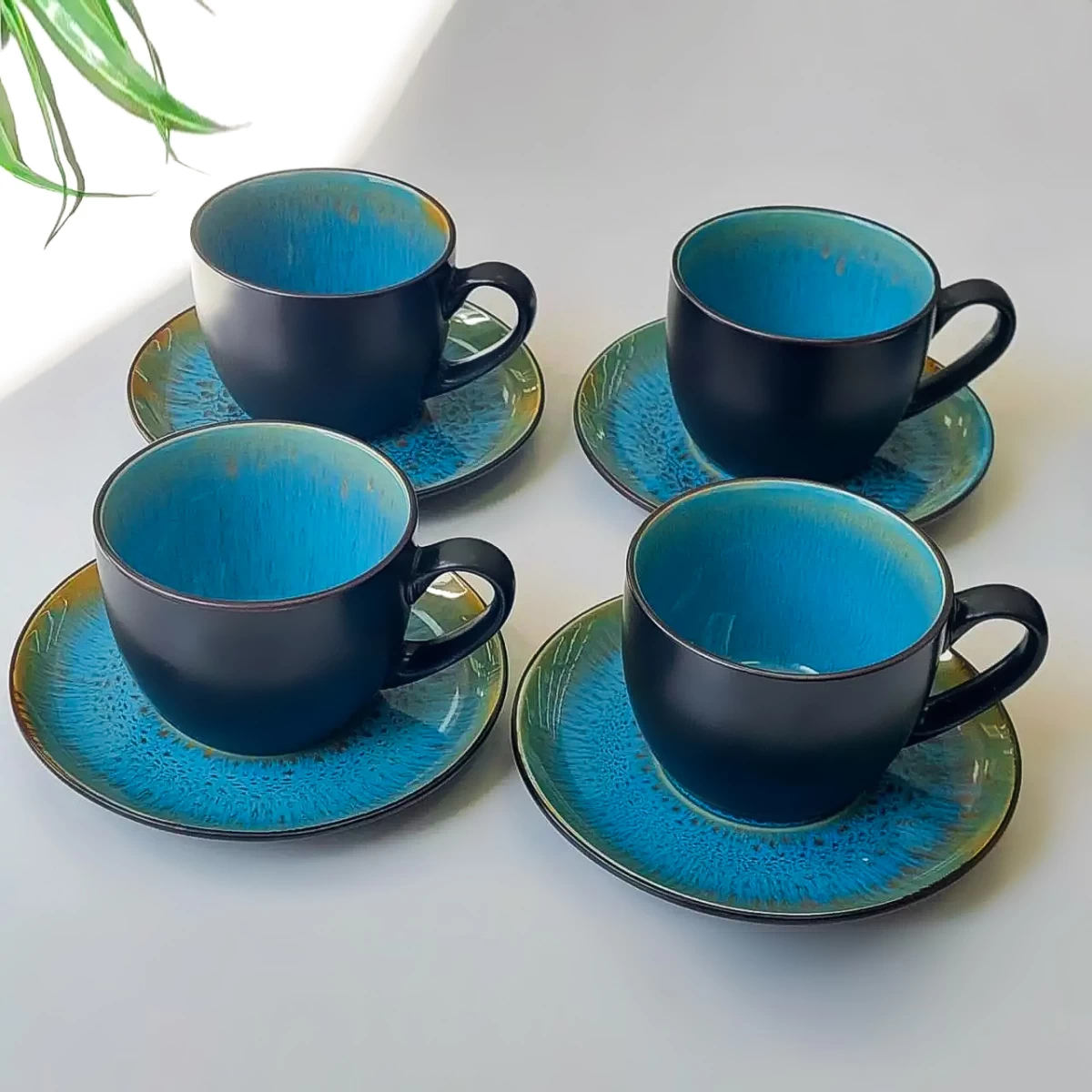Six fluted stacking mugs in warm neutral and coral tones